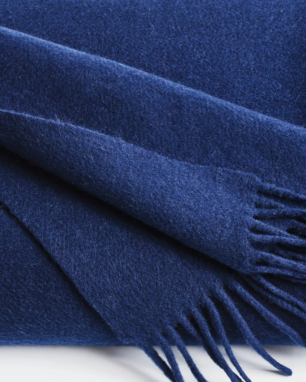 close-up detail of navy cashmere fringe throw by Home of Cashmere