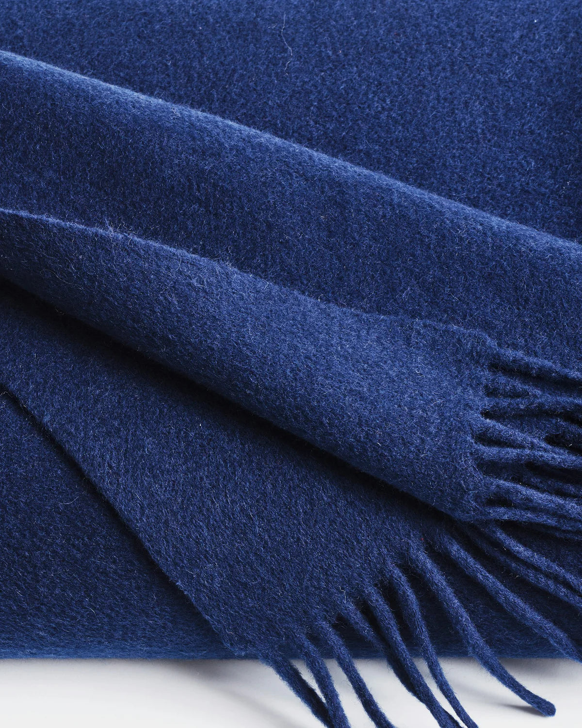 close-up detail of navy cashmere fringe throw by Home of Cashmere